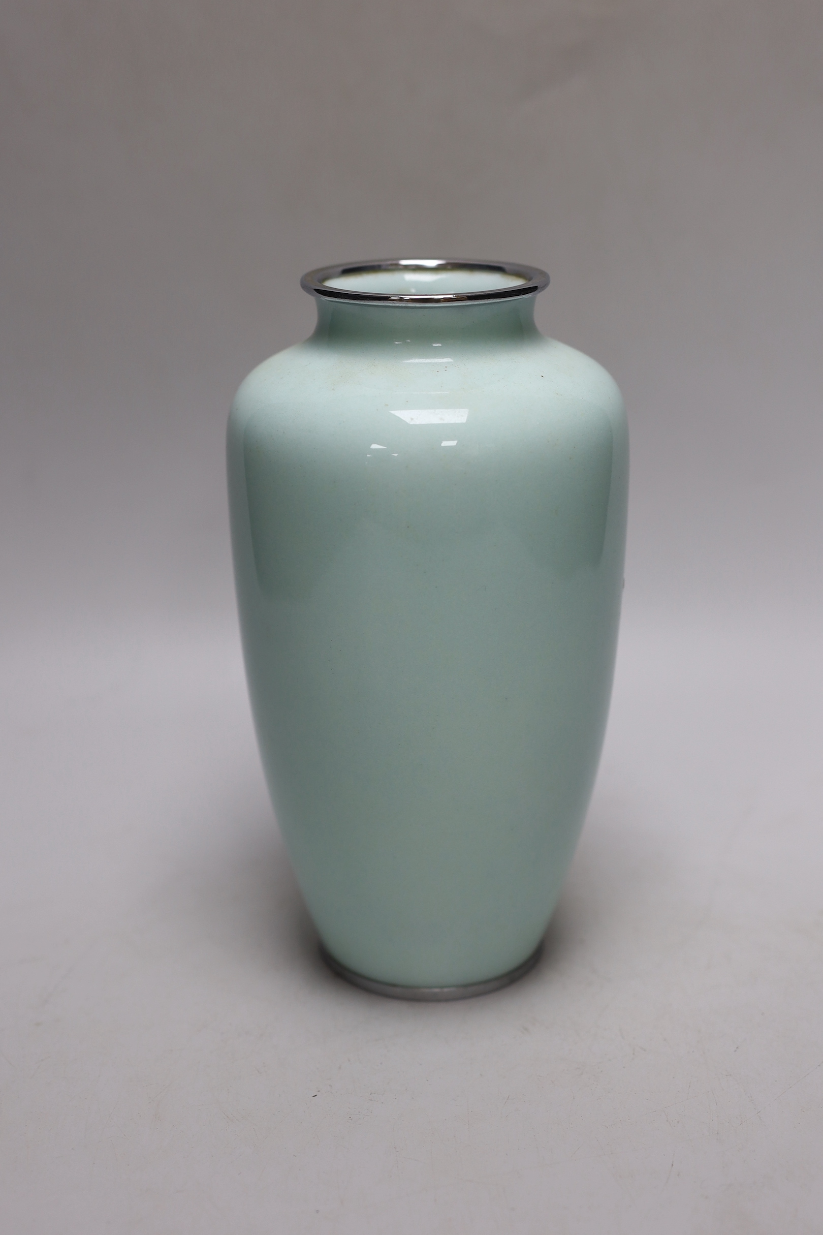 A Japanese cloisonné enamel vase decorated with roses upon a pale blue ground, silvered rim and base, 22cm high